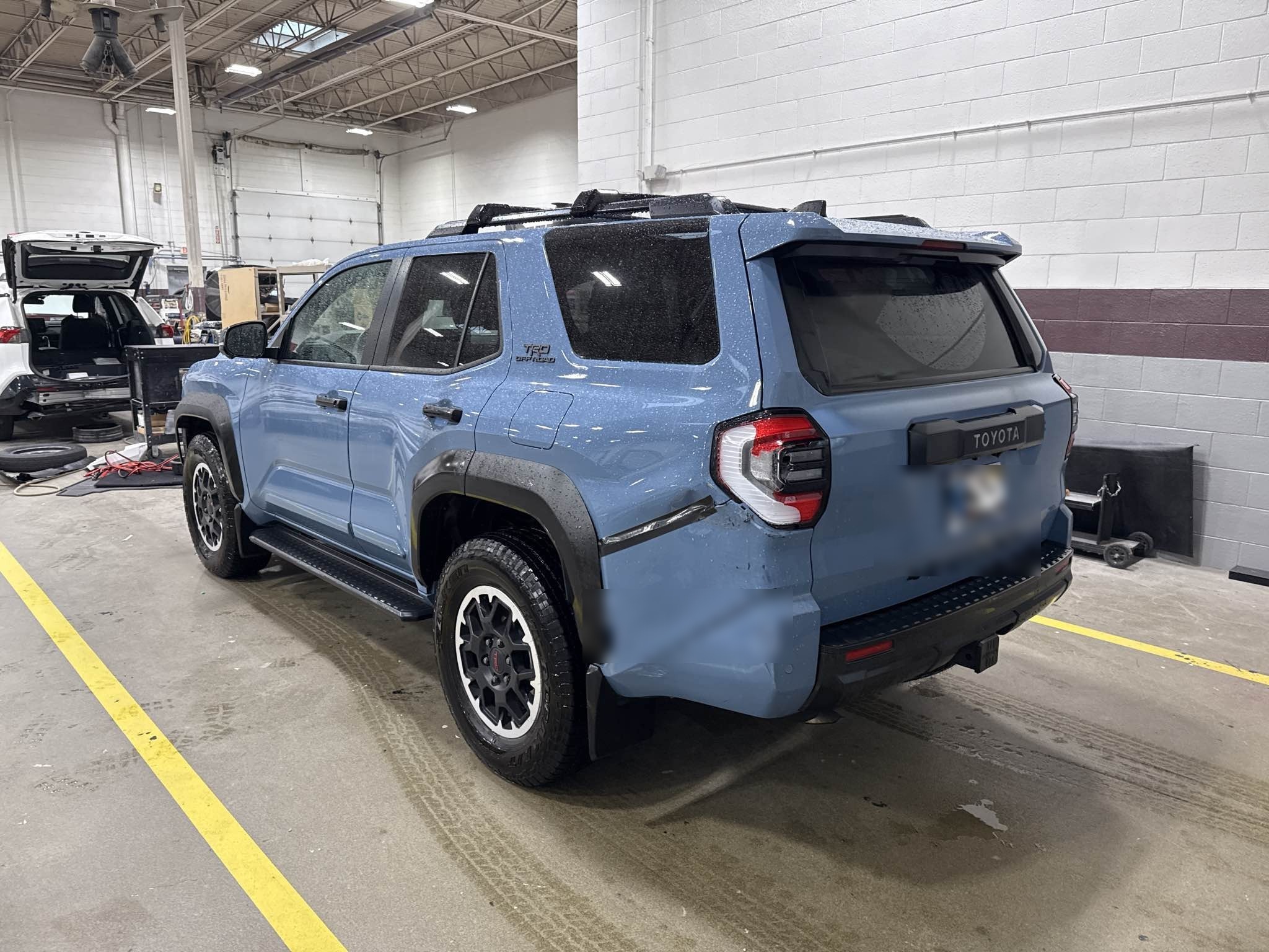 2025 Toyota 4Runner TRD Off-Road in Cavalry Blue with collision repair completed, photographed inside Bob Rohrman Collision Repair Center in Lafayette, Indiana