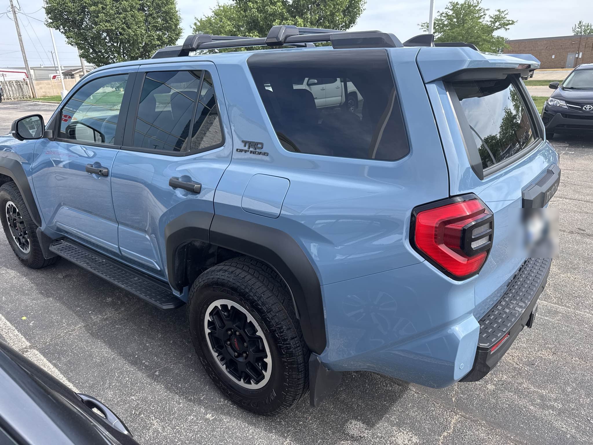 2025 Toyota 4Runner TRD Off-Road in Cavalry Blue fully restored after rear driver-side collision repair, photographed outdoors at Bob Rohrman Collision Repair Center in Lafayette, Indiana