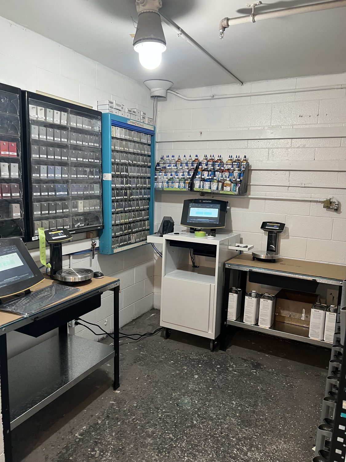 The remodeled paint mixing room at Bob Rohrman Collision with new BASF Refinity scale, toner racks, and benches in Lafayette, Indiana